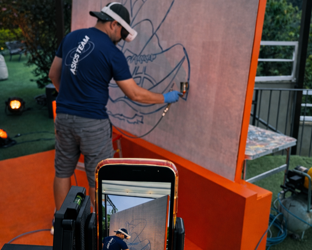 Painel pintado ao vivo durante evento corporativo da ASICS